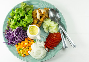 Fried chicken Salad in Plate on white background, Healthy salad diet food concept, Top view, with copy space for your text..