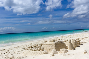 Fototapeta na wymiar Sandy castle on caribbean coast, Aruba beach