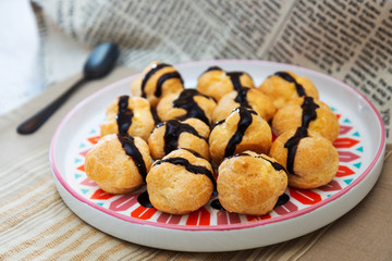 Profiterole with vanilla and chocolate sauce