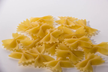 Macaroni bows on white background near