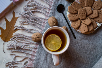 A cup of tea with lemon and cakes. Hygge flat lay.