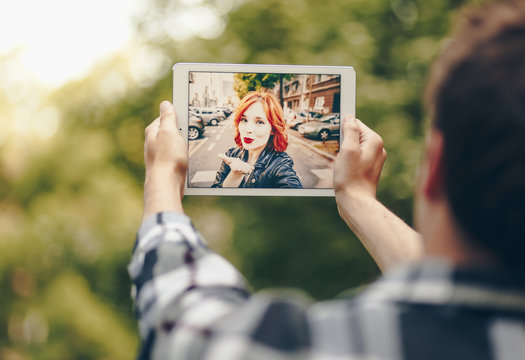 Young couple in love chatting over a video call, by using a tablet.