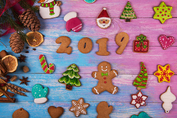 Obraz na płótnie Canvas Gingerbreads for new 2019 year on wooden background, xmas theme