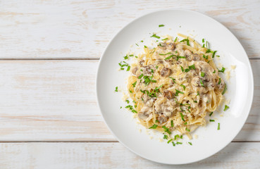 Spaghetti with mushrooms in cream sauce. Copy space for your text.