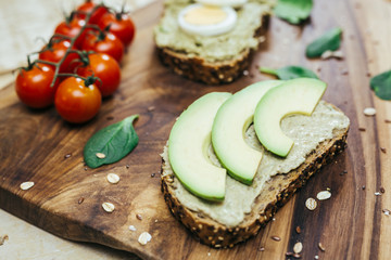 avocado sandwiches on rustic wooden table