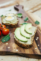 avocado sandwiches on wooden table