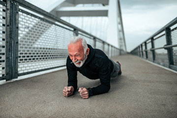 Sportsman doing plank exercise in the city.