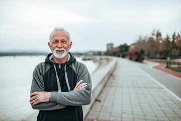 Portrait of a active senior in sportswear by the river.