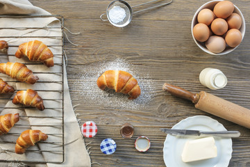 Hand made croissant and ingredients to make it on a wooden table