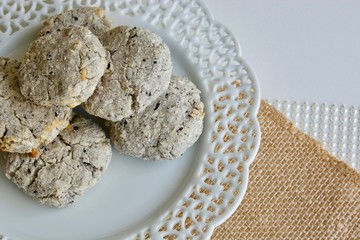 Tasty coconut cookies on the white plate on the white background