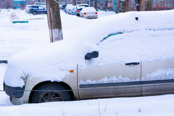 front of a car covered in snow after a recent blizzard
