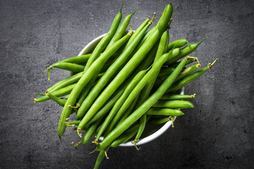 Green beans on black background. 