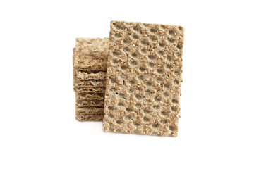 One main crispbread against the background of stack of crispbread with sesame isolated on white