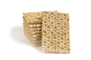 One main crispbread against the background of stack of crispbread with sesame isolated on white