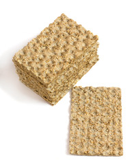 One main crispbread and stack of crispbread with sesame isolated on white. Top view. Vertical
