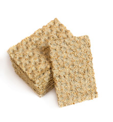 One main crispbread against the background of stack of crispbread with sesame isolated on white