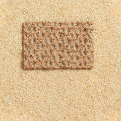 Healthy bread crisp against the background of sesame seeds background.