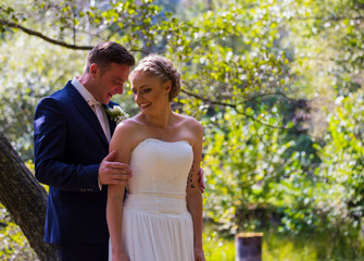 Fototapeta premium Happy couples together in nature. Wedding and wedding dress. Bouquet of white roses. Love.