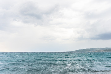 Naklejka na ściany i meble Sea water waves on cloudy day, nature background . Ocean view on cloudy summer day