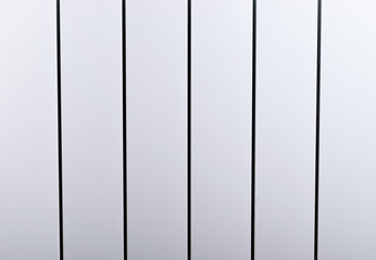 A White heating radiator on the wall.