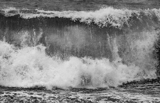 Fototapeta stormy weather at the black beach with high waves