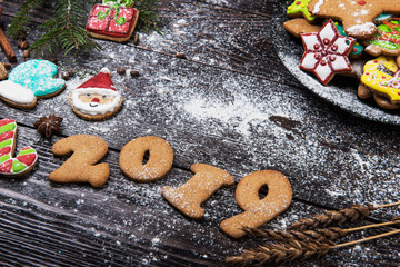 Gingerbreads cookies for new years and christmas on wooden background, xmas theme