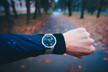 Smart watch with symbol of running man on display. Inteligent watch, activity, motivation photo