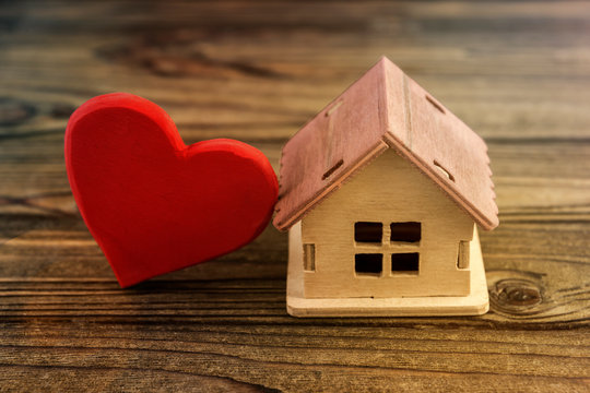 wooden house, heart on wooden background. love, family values