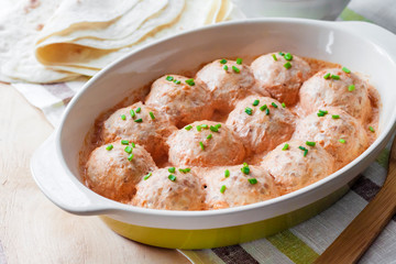 Chacken meatballs baked in creamy tomato sauce