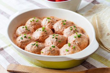 Chacken meatballs baked in creamy tomato sauce