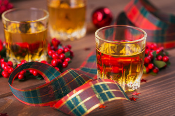 Whiskey, brandy or liquor shot and Christmas decorations