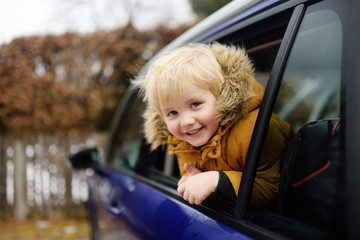 Cute little boy ready for a roadtrip or travel. Family car travel with kids