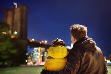 Father and his little son looking at the Brooklyn bridge
