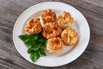 Sweet buns in the form of roses on a white plate, closeup