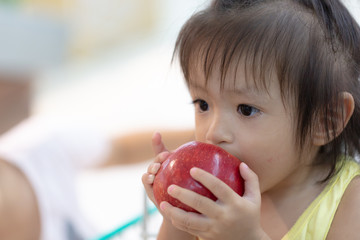  Asian kid eating an apple