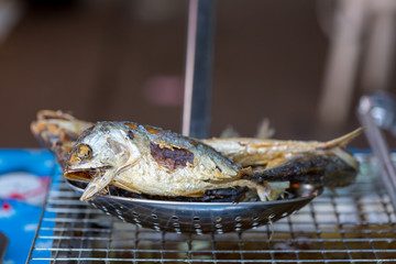 Fried mackerel fish put on the grill to drain oil.