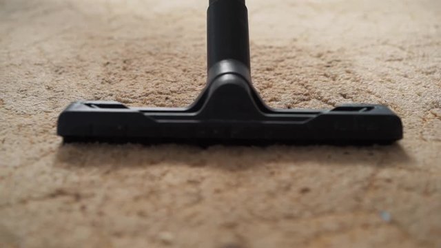 Vacuum cleaner cleaning the carpet.