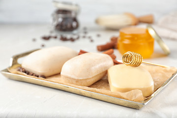 Different soap bars in tray with parchment paper on light table
