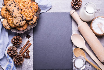 Fototapeta na wymiar Delicious freshly baked homemade cookies and products for baking on a gray wooden table. Christmas concept. Flat lay