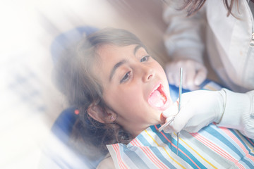 Young girl with open mouth for dental inspection