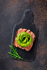 Healthy toasts with salmon and avocado rose