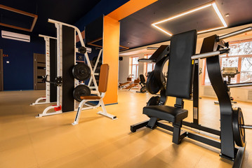 Fototapeta na wymiar New fitness machines in modern gym interior