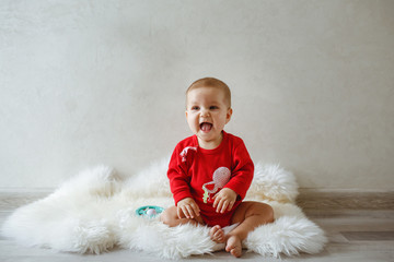 A little girl at the photo shoot, dressed in red coat.