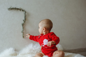 A little girl dressed in a dress. Girls 7 months old.