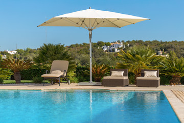 Sun bath with sun loungers and parasol. In Portugal.