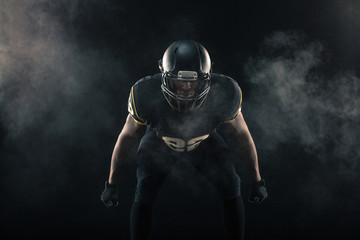 African American football player isolated on black. © digitalskillet1