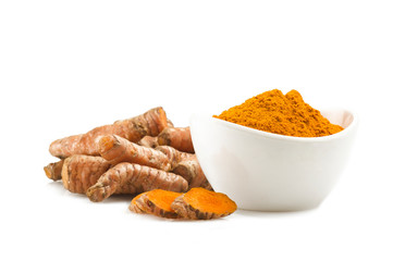 turmeric root and some slices on a white background