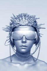 Futuristic woman in metal helmet and glasses