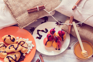 Breakfast  with croissants, honey  and canapés of strawberries and apricots