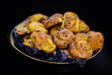 Buns with raisins on a black background